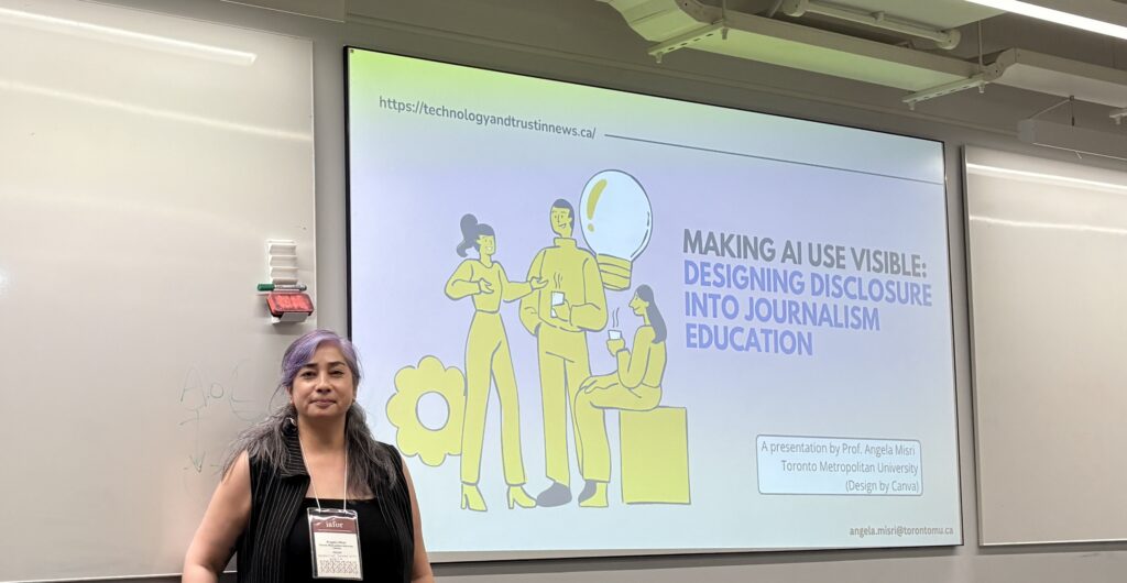 A photo of a woman standing in front of a presentation projected on a screen.
